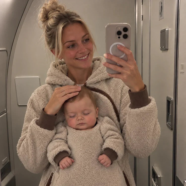 Parent wearing the LazyNest hoodie with baby tucked inside