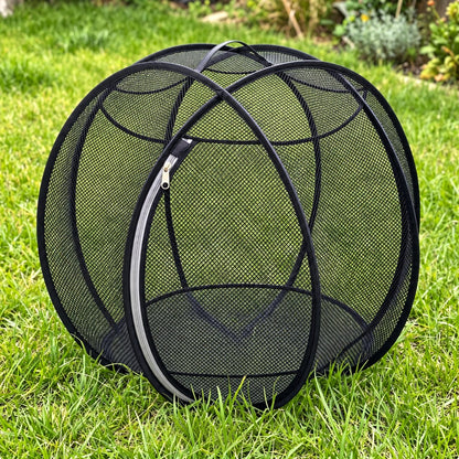 Pup Palace pop-up mesh pet playpen ball in Black on the grass