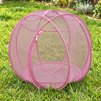 Pup Palace pop-up mesh pet playpen ball in Pink on the grass